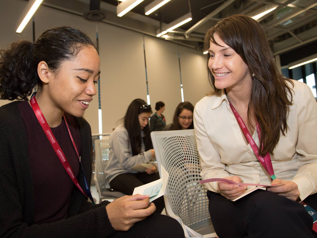 Marisa talking with a student at a campus event